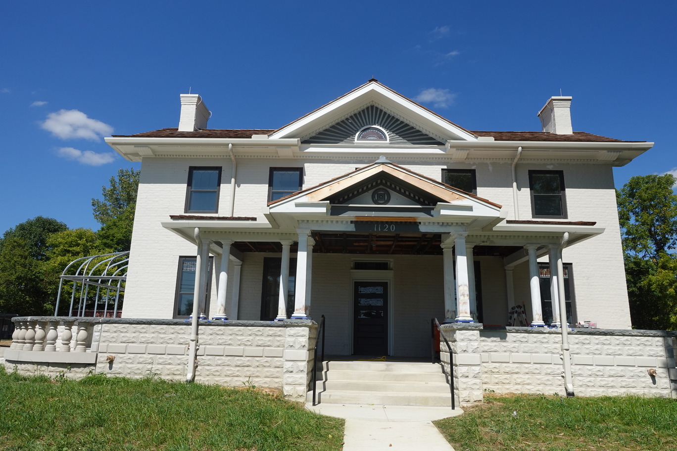 Two story brick building with two chimneys. 
