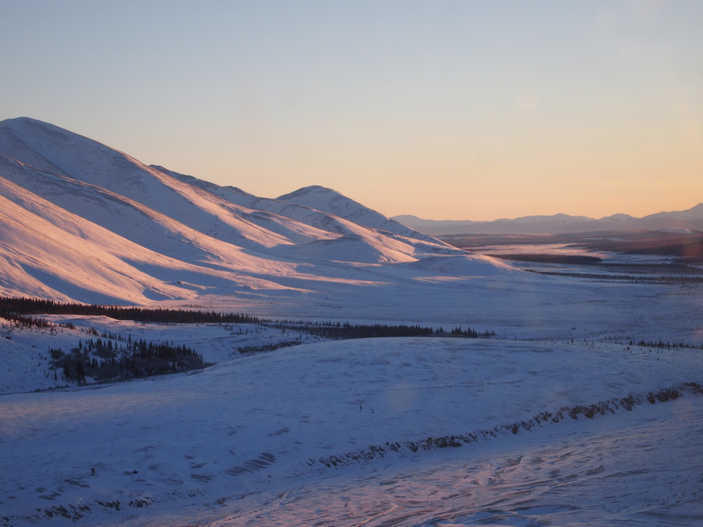 Sunset glow off snowy mountains