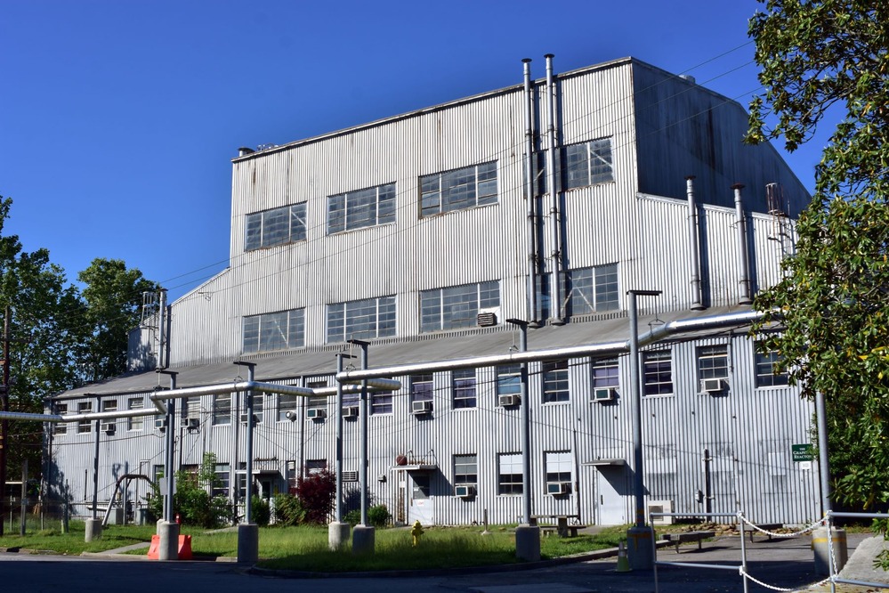 A large industrial building with silver colored corrugated metal exterior.
